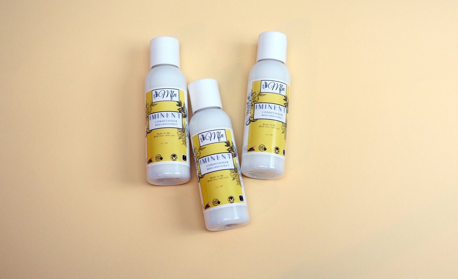 Three bottles of Iminent Conditioner with caffeine extract