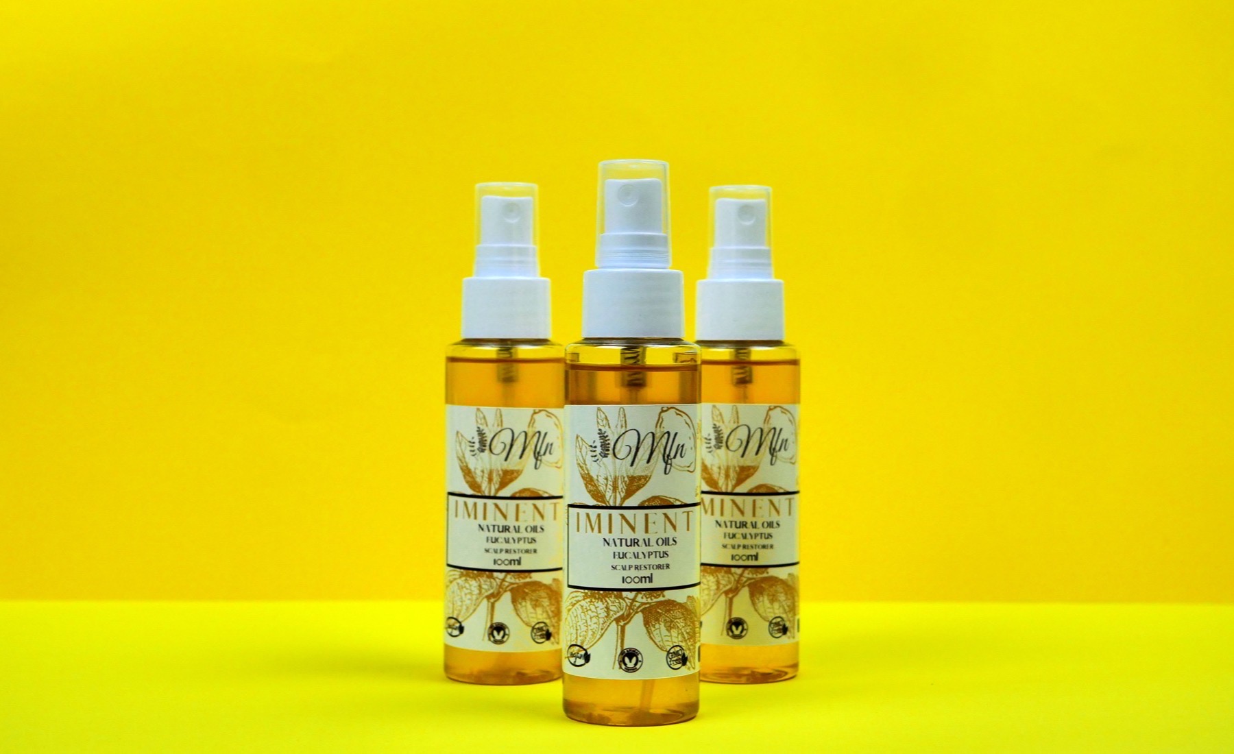 Three bottles of Iminent natural hair and scalp oil