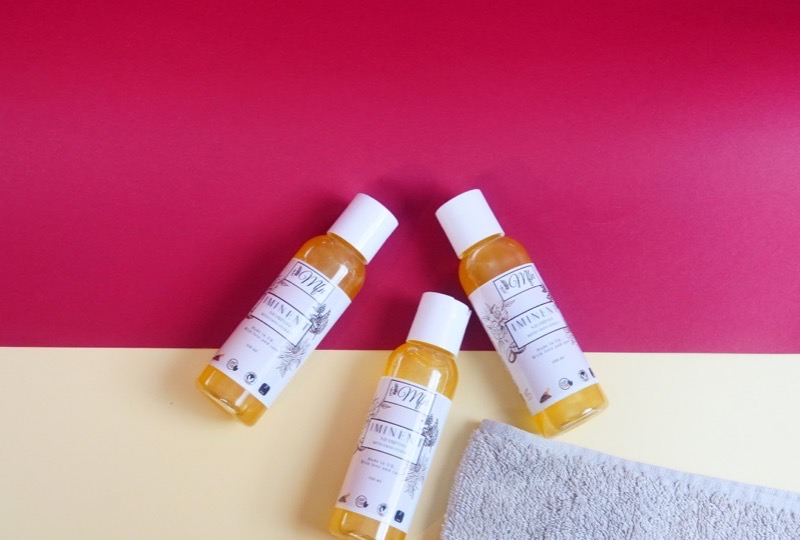 Bottles of Iminent Shampoo with caffeine extract